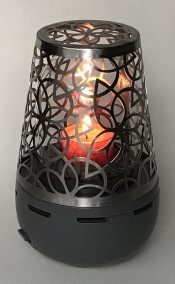 The glass dome inside the decorative metal cover sits over the flame